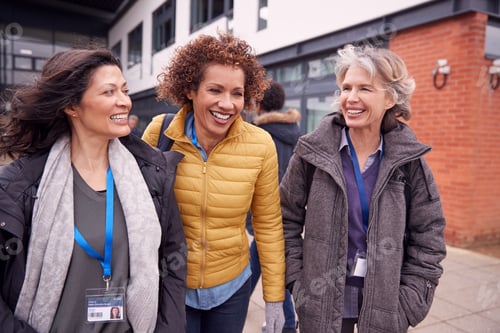 Preview: Group Of Smiling Female Mature Students Walking Outside College Building