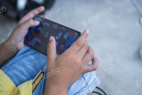 Preview: hand boy touching on monitor smartphone for playing game
