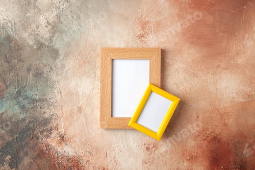 Preview: Top view of small and big colorful photo frames hanging on mix color wall with free space