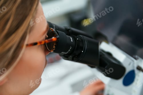 Preview: Close-up of woman using microscope