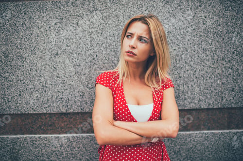 Preview: Worried serious woman standing in street