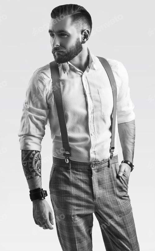 Preview: Portrait Of Brutal Elegant Man In Gray Classic Pants And Suspenders Isolated On White Background In