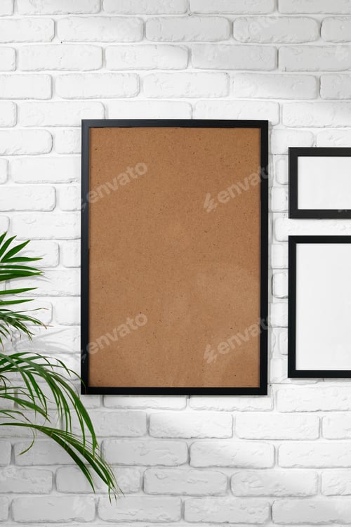 Preview: Black picture frame hanging on white brick wall copy space