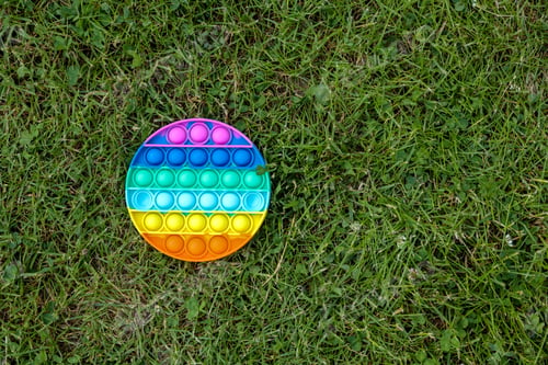 Preview: Pop It Simple Dimple - round silicone sensory anti-stress Fidget toy multi-colored game on green