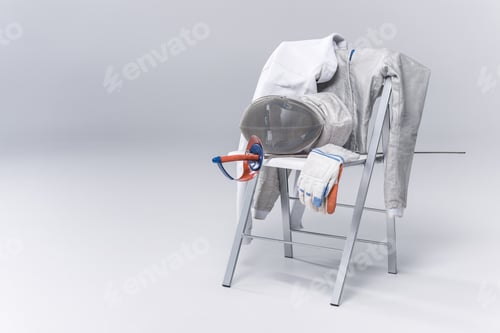 Preview: Professional fencing equipment on chair isolated on grey background