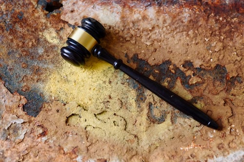 Preview: Gavel on rusted metal surface showing symbol of outdated justice