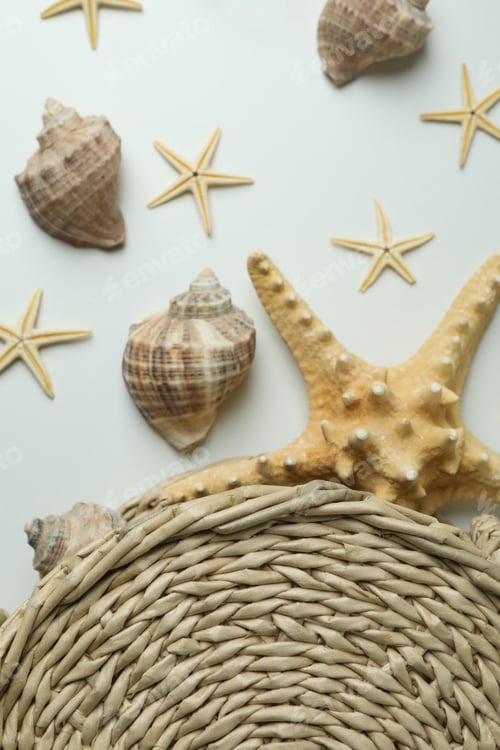 Preview: Straw bag and seashells on white background