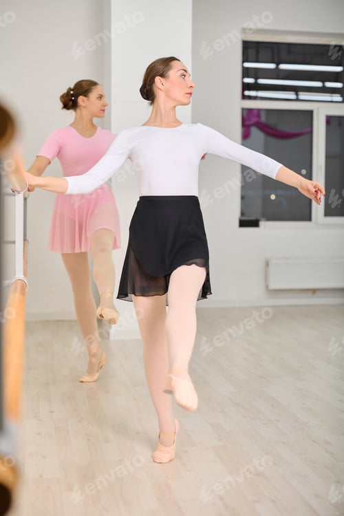 Preview: Young ballerinas at ballet barre in dance rehearsal