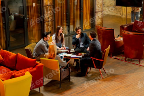 Preview: top shot in large beautiful hall office employees sitting on yellow chairs discuss a deal