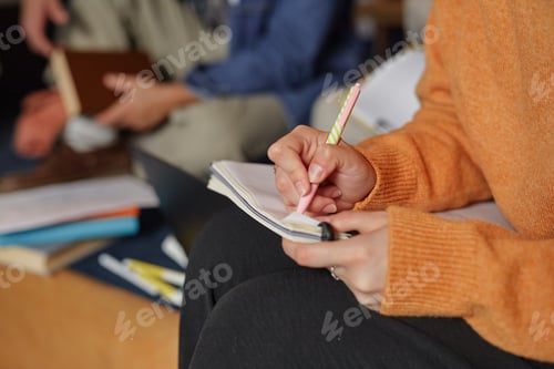Preview: Girl Taking Notes during Group Study Session