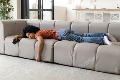Preview: Exhaustion Concept. Tired Young Black Woman Sleeping On Couch At Home