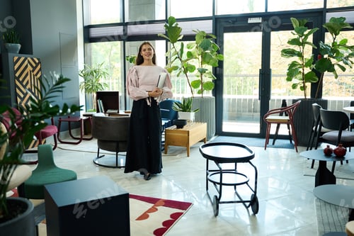 Preview: Beautiful young woman stands in a spacious, bright room
