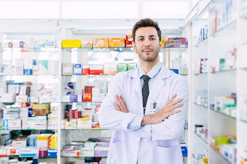 Preview: Pharmacist man smart arm crossed in Pharmacy health service in drugstore, professional