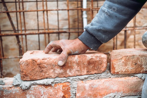 Preview: Construction mason, industry worker laying bricks and building walls on construction site
