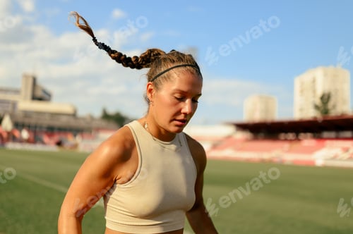 Preview: Close shot of a female marathon runner in sports arena