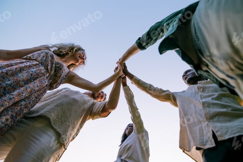 Preview: Startup team giving high five outdoors celebrating success