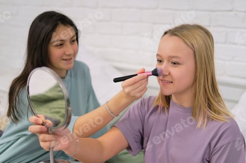Preview: friends putting makeup on together in the bathroom. Children's pajama party.