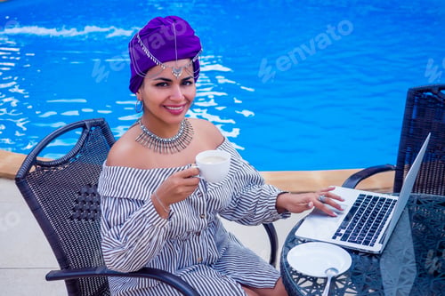 Preview: Beautiful mixed race woman remote working in the coffee shop summer