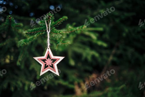 Preview: Wooden Christmas hanger in form of a star hanging on a fir tree