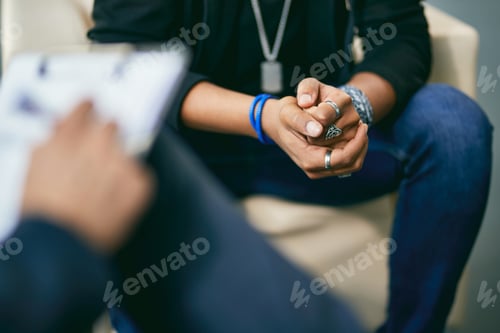 Preview: Close-up of black adolescent having a therapy session with psychologist.