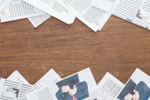Preview: top view of different newspapers on wooden tabletop