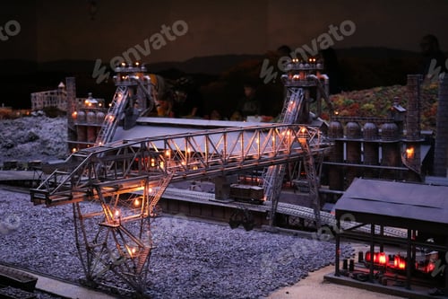 Preview: Closeup of a factory model with cranes and lights on the display