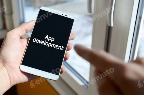 Preview: A person sees a white inscription on a black smartphone display that holds in his hand