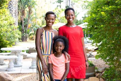 Preview: Senior African American woman spending time with her daughter and her granddaughter in the garden