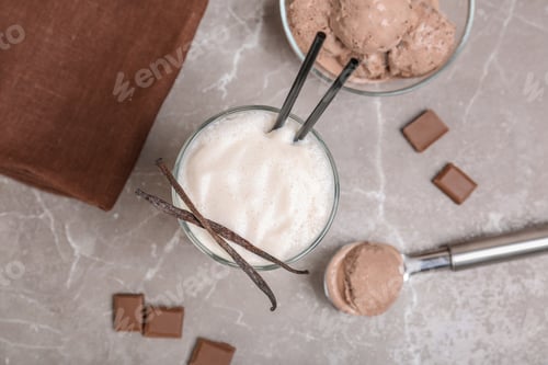 Preview: Flat lay composition with delicious milk shake on grey background