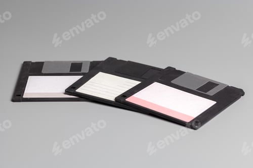 Preview: Three old computer diskette over grey background