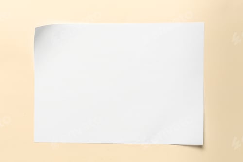 Preview: Blank paper rests on a light surface during the day in a simple workspace