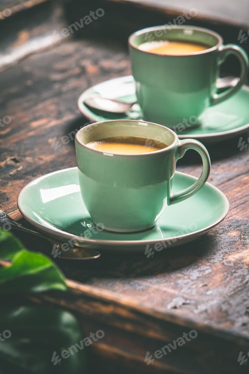 Preview: Cups of coffee and capsules, close up