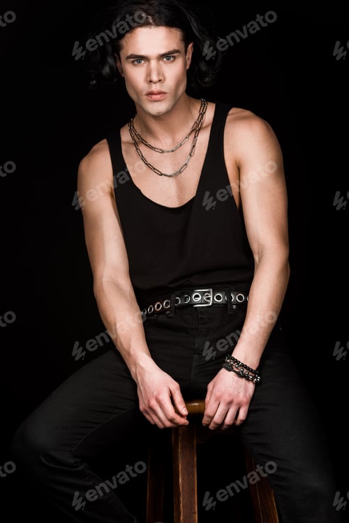 Preview: handsome man sitting on wooden chair isolated on black