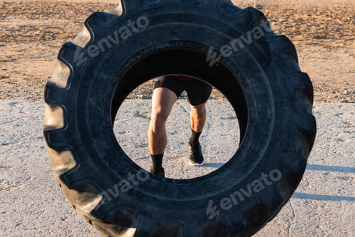 Preview: Anonymous strong man doing tire flip exercise