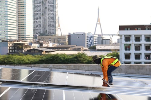 Preview: Technicians Install photovoltaic solar modules on roof of house.