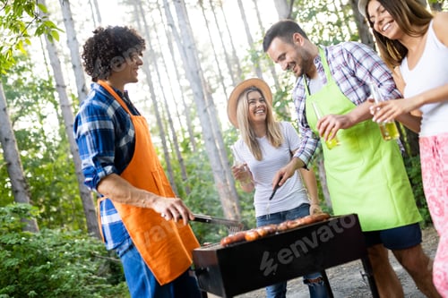 Preview: Group of happy friends having a barbecue party in nature