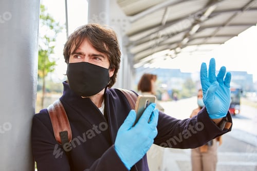 Preview: Commuters With Face Masks Because Of Covid-19 And Smartphones With A Warning App In Local Traffic