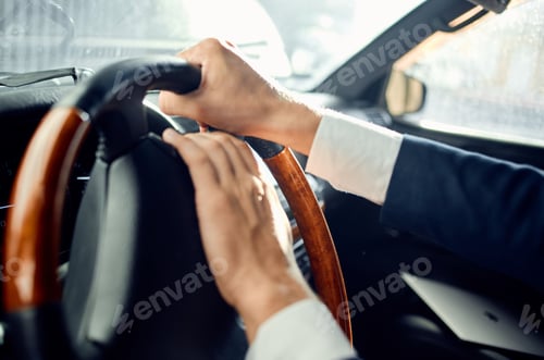 Preview: bearded man in a suit in a car a trip to work success