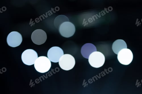 Preview: bokeh lights. blurred night white blue gray abstract texture glowing neon light on black background.
