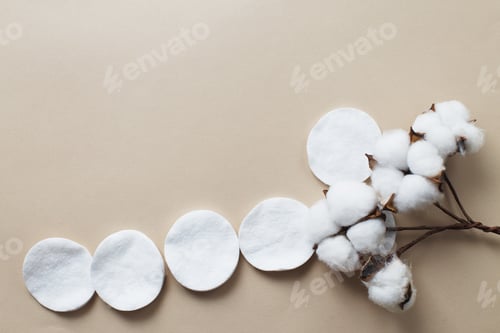Preview: fluffy cotton flower cotton pads on beige background with copy space. hygienic disposable product