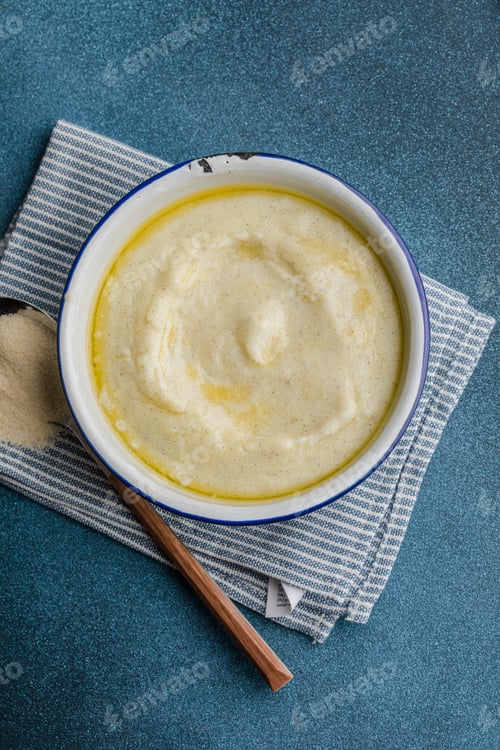 Preview: Semolina porridge in a vintage bowle for a breakfast on blue table