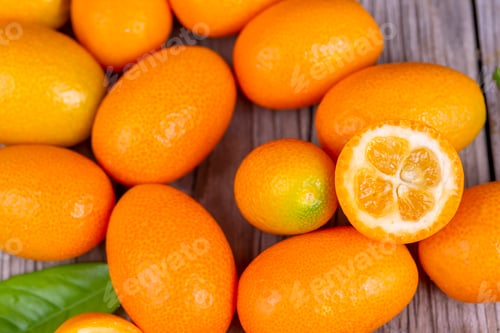 Preview: Top view of bunch of fresh kumquats in the organic food market.
