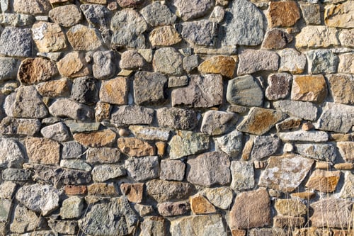 Preview: Background from a wall with stones in sunlight