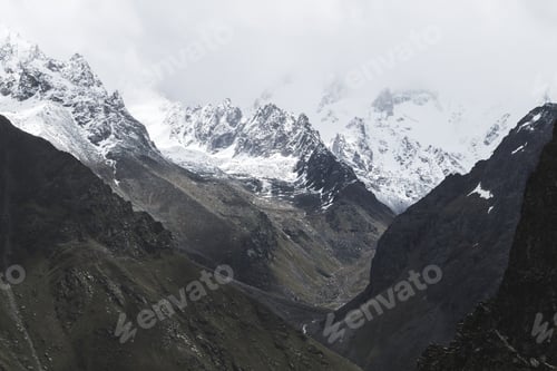 Preview: Snow mountain peaks of Caucasus mountains in cold cloudy weather, Elbrus Region.
