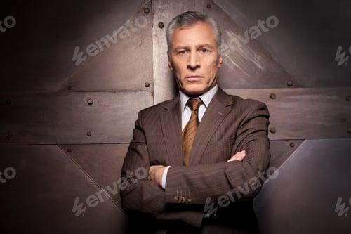 Preview: Power in his veins. Confident senior man in formalwear holding arms crossed and looking at camera