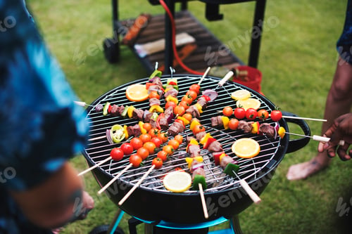 Preview: Group of diverse friends grilling barbecue outdoors