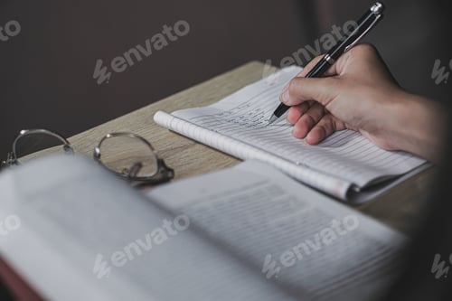 Preview: Closeup of girl writing on her journal