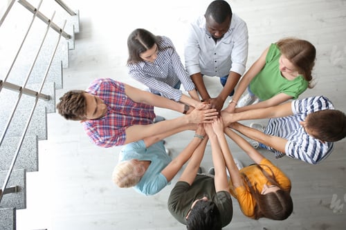 Preview: People putting hands together indoors. Unity concept