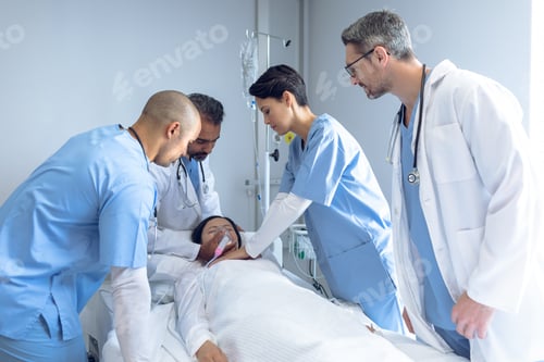 Preview: Side view of diverse doctors examining Asian female patient in bed in ward at hospital.