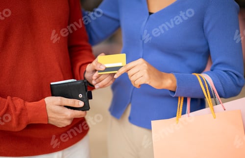 Preview: Cropped Shot Of Husband Giving Credit Card To Wife Indoors